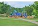 Community playground with colorful slides and play structures in a grassy area at 1005 Woodbury Rd, Canton, GA 30114
