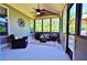 Comfortable screened-in porch with wicker furniture and nature views at 1005 Woodbury Rd, Canton, GA 30114