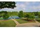 Community tennis courts surrounded by mature trees and lush landscaping at 1005 Woodbury Rd, Canton, GA 30114