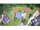 Aerial view of the home showcases the property's layout, landscaping, and proximity to surrounding trees at 21 Wisteria Run, Hiram, GA 30141