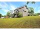 Spacious, grassy backyard featuring a private deck with stairs, and surrounding mature trees at 21 Wisteria Run, Hiram, GA 30141