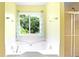 Bathroom showcasing a soaking tub and separate glass-enclosed shower at 21 Wisteria Run, Hiram, GA 30141