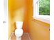Cozy bathroom featuring a toilet and a window offering a serene view at 21 Wisteria Run, Hiram, GA 30141