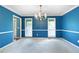 Elegant dining room with windows providing natural light, complete with classic chandelier at 21 Wisteria Run, Hiram, GA 30141