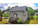 Rear view of home featuring a spacious deck, with mature trees at 21 Wisteria Run, Hiram, GA 30141