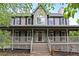 Charming home featuring a covered front porch, neutral siding, and a classic architectural style at 21 Wisteria Run, Hiram, GA 30141