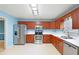 Well-equipped kitchen featuring stainless steel appliances, wood cabinets, and a functional layout at 21 Wisteria Run, Hiram, GA 30141