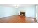 Spacious living room with a brick fireplace and hardwood floors, offering a cozy ambiance at 21 Wisteria Run, Hiram, GA 30141