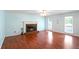 Expansive living room featuring hardwood floors and a classic brick fireplace for relaxation at 21 Wisteria Run, Hiram, GA 30141