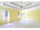 Bright main bedroom featuring tray ceilings and lots of windows for natural light at 21 Wisteria Run, Hiram, GA 30141