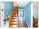 Stairway with hardwood steps and a lift, leading to the upper level, bright blue walls at 21 Wisteria Run, Hiram, GA 30141