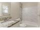 A remodeled bathroom features a marble-topped sink and tiled bathtub at 2469 Newgate Dr, Decatur, GA 30035