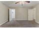 A carpeted bedroom with a ceiling fan has two doors, one leading to a closet at 2469 Newgate Dr, Decatur, GA 30035