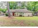 Charming single story home with brick accents, manicured landscaping and a bright red front door at 2469 Newgate Dr, Decatur, GA 30035