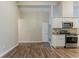 Modern kitchen with white cabinets, stainless steel appliances, and open access to the living room at 2469 Newgate Dr, Decatur, GA 30035
