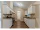 Bright kitchen with white cabinets, granite countertops, stainless steel appliances, and wood flooring at 2469 Newgate Dr, Decatur, GA 30035
