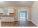 View of the kitchen with an open layout, white cabinets, granite countertops, and a view to the deck at 2469 Newgate Dr, Decatur, GA 30035