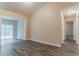 Bright living room with gray wood flooring, a sliding glass door to the deck, and access to a hallway at 2469 Newgate Dr, Decatur, GA 30035