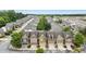 Aerial view showcases modern townhomes with well-manicured lawns and tree-lined streets at 2647 Sardis Chase Ct, Buford, GA 30519