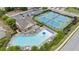 Overhead view featuring community pool and tennis courts next to clubhouse and parking area at 2647 Sardis Chase Ct, Buford, GA 30519