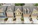 Aerial view showing modern townhomes with attached garages and well-manicured lawns at 2647 Sardis Chase Ct, Buford, GA 30519