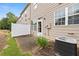 A home's backyard features a small patio, a partial privacy fence, and lush green plants at 2647 Sardis Chase Ct, Buford, GA 30519