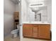 Bathroom featuring double sinks, wooden cabinets, and a separate toilet area at 2647 Sardis Chase Ct, Buford, GA 30519