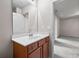 Bathroom vanity featuring wood cabinets, white countertops, and a large mirror reflecting the adjacent room at 2647 Sardis Chase Ct, Buford, GA 30519
