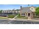 Brick clubhouse with well-kept landscaping and the neighborhood tennis courts in the background at 2647 Sardis Chase Ct, Buford, GA 30519