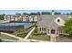 View of the brick clubhouse featuring manicured landscaping and the tennis courts on the left at 2647 Sardis Chase Ct, Buford, GA 30519