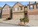 Beautiful townhome with a two-car garage and inviting curb appeal with green landscaping at 2647 Sardis Chase Ct, Buford, GA 30519