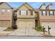 Charming townhome featuring a two-car garage, stone accents and manicured landscaping at 2647 Sardis Chase Ct, Buford, GA 30519
