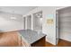Kitchen island with granite countertop next to a large pantry and an open living space at 2647 Sardis Chase Ct, Buford, GA 30519