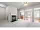 Open-concept living room with fireplace, columns, and view into the kitchen area at 2647 Sardis Chase Ct, Buford, GA 30519
