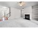 Bright living room with fireplace, neutral decor, and view of the staircase at 2647 Sardis Chase Ct, Buford, GA 30519