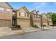 Street view showcasing townhomes with well-maintained landscaping and two-car garages at 2647 Sardis Chase Ct, Buford, GA 30519