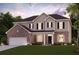 Beautiful two-story home featuring a brick and siding facade, manicured lawn, and a two-car garage at 720 Hedwig Dr, Mcdonough, GA 30252