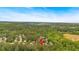 Scenic aerial view of a neighborhood nestled among lush trees and rolling hills with a blue sky at 10 Bayberry Ct, Acworth, GA 30101