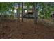 A beautiful two-story home with a private backyard and mature trees and wooden fence at sunset at 10 Bayberry Ct, Acworth, GA 30101
