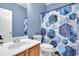 Bathroom with a geometric shower curtain, vanity, toilet, and mirror at 10 Bayberry Ct, Acworth, GA 30101