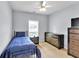 Bedroom with a blue bed, wooden dresser, and a window providing natural light at 10 Bayberry Ct, Acworth, GA 30101