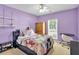 Charming bedroom with purple walls, shelving, and window for natural light at 10 Bayberry Ct, Acworth, GA 30101