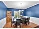 Formal dining room with navy walls, wainscoting, hardwood floors, and traditional wood furniture at 10 Bayberry Ct, Acworth, GA 30101