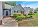Charming home with well-manicured landscaping, flowering bushes, and a covered entry, creating an inviting curb appeal at 10 Bayberry Ct, Acworth, GA 30101