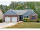 Charming home featuring brick accents, a two-car garage, and lush landscaping at 10 Bayberry Ct, Acworth, GA 30101