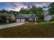 Attractive exterior view of home with driveway, green lawn, and blue sky at 10 Bayberry Ct, Acworth, GA 30101