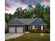 Charming one-story home featuring a well-manicured lawn and mature trees, with a two-car garage and inviting entry at 10 Bayberry Ct, Acworth, GA 30101