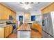 Well-lit kitchen with wood cabinets, stainless steel appliances, granite countertops, and wood floors at 10 Bayberry Ct, Acworth, GA 30101