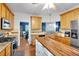 Open kitchen with stainless appliances, island with butcher block countertop, and hardwood floors at 10 Bayberry Ct, Acworth, GA 30101