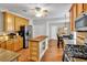 Well-equipped kitchen with stainless appliances, granite countertops, a butcher block island, and wood floors at 10 Bayberry Ct, Acworth, GA 30101
